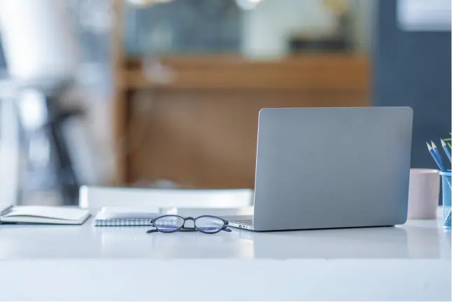 Photo of desk top with PC and notebook